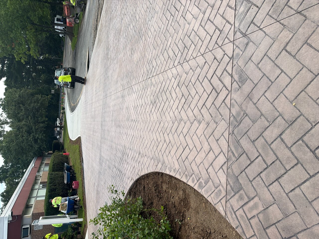 Herringbone brick stamped concrete driveway at a commercial building