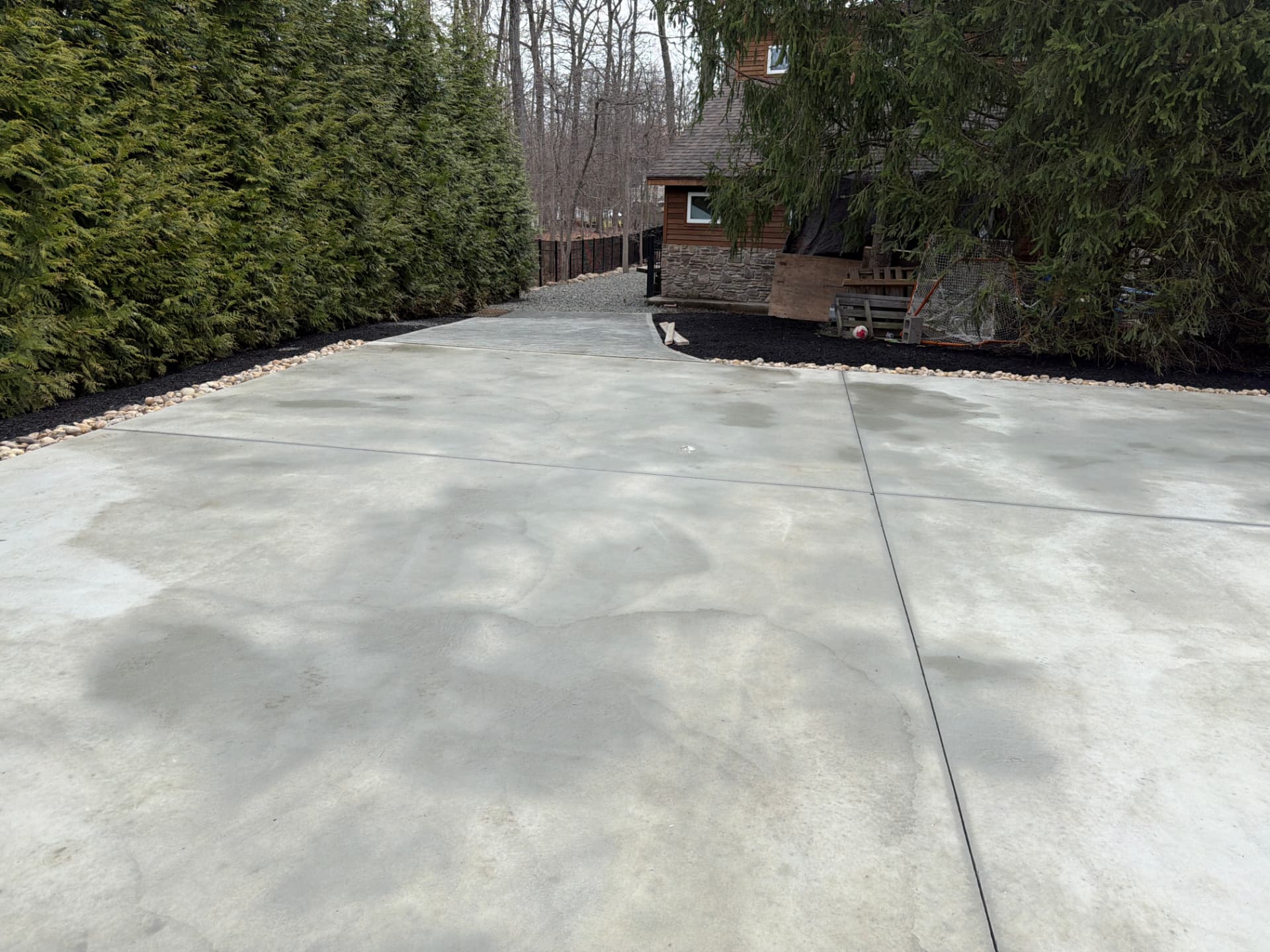 Broom finish concrete patio with stone border