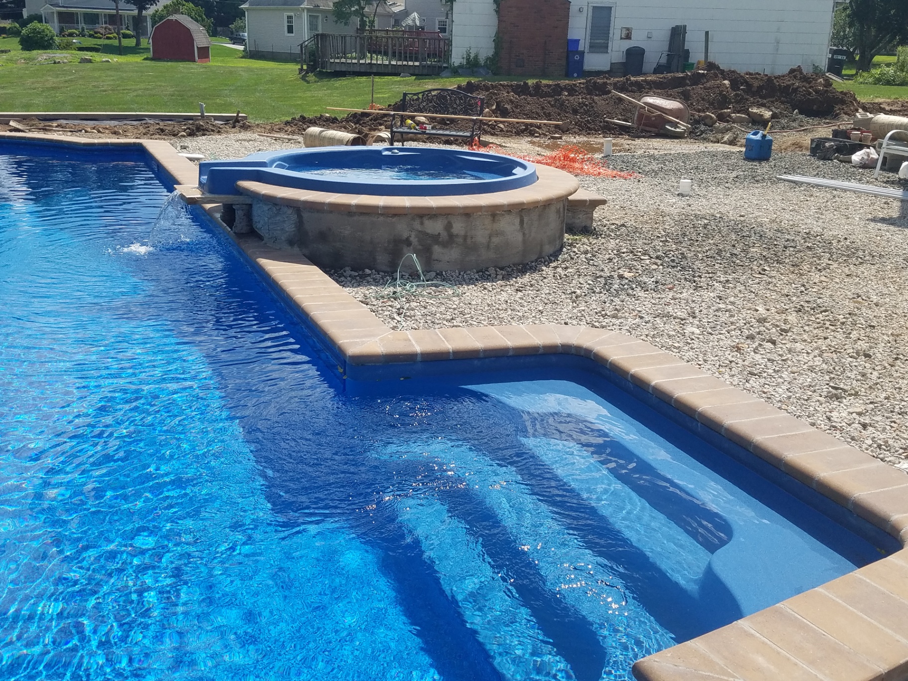 Pool with attached spa and brick coping