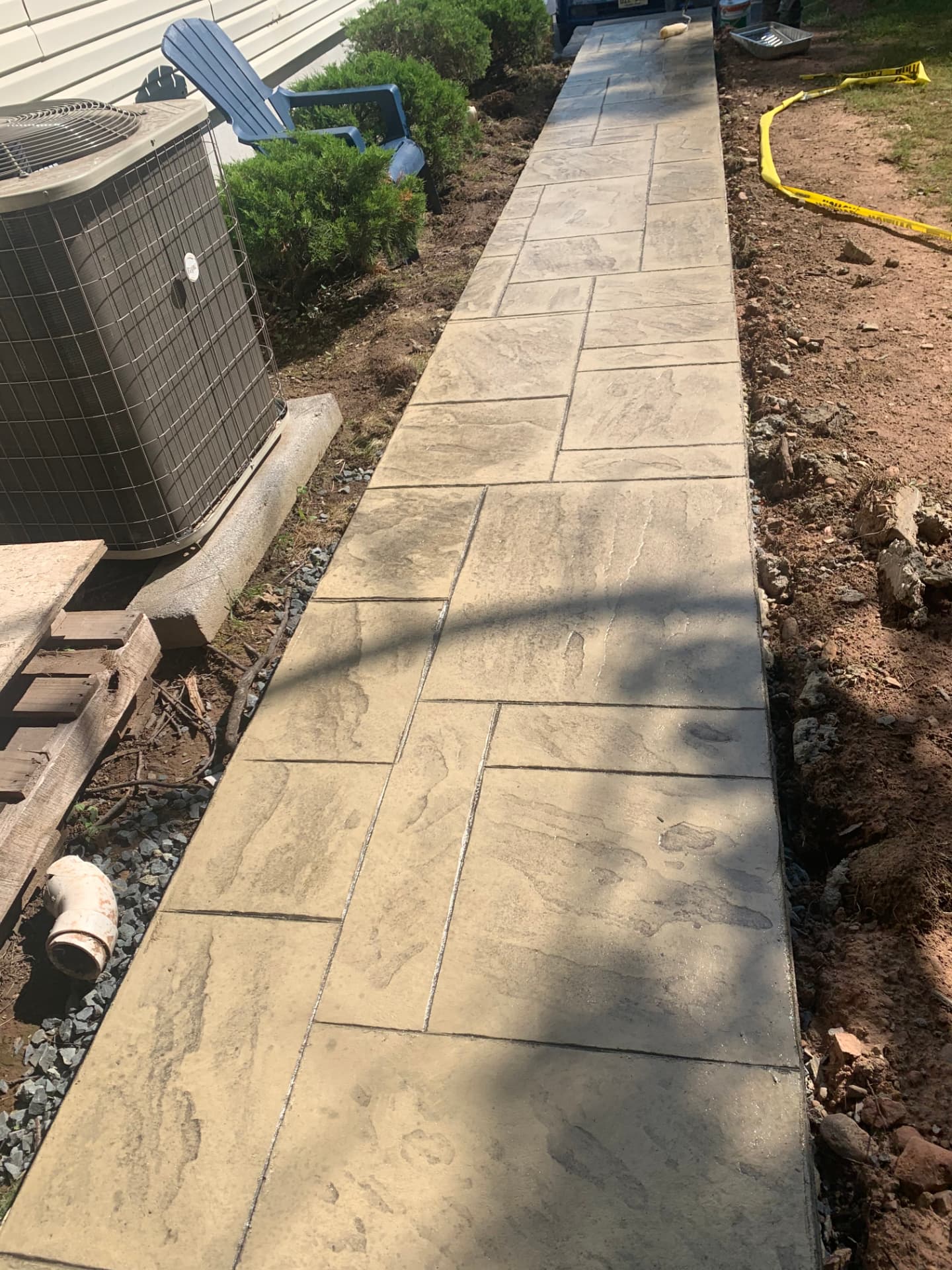 Tan ashlar stamped concrete side walkway