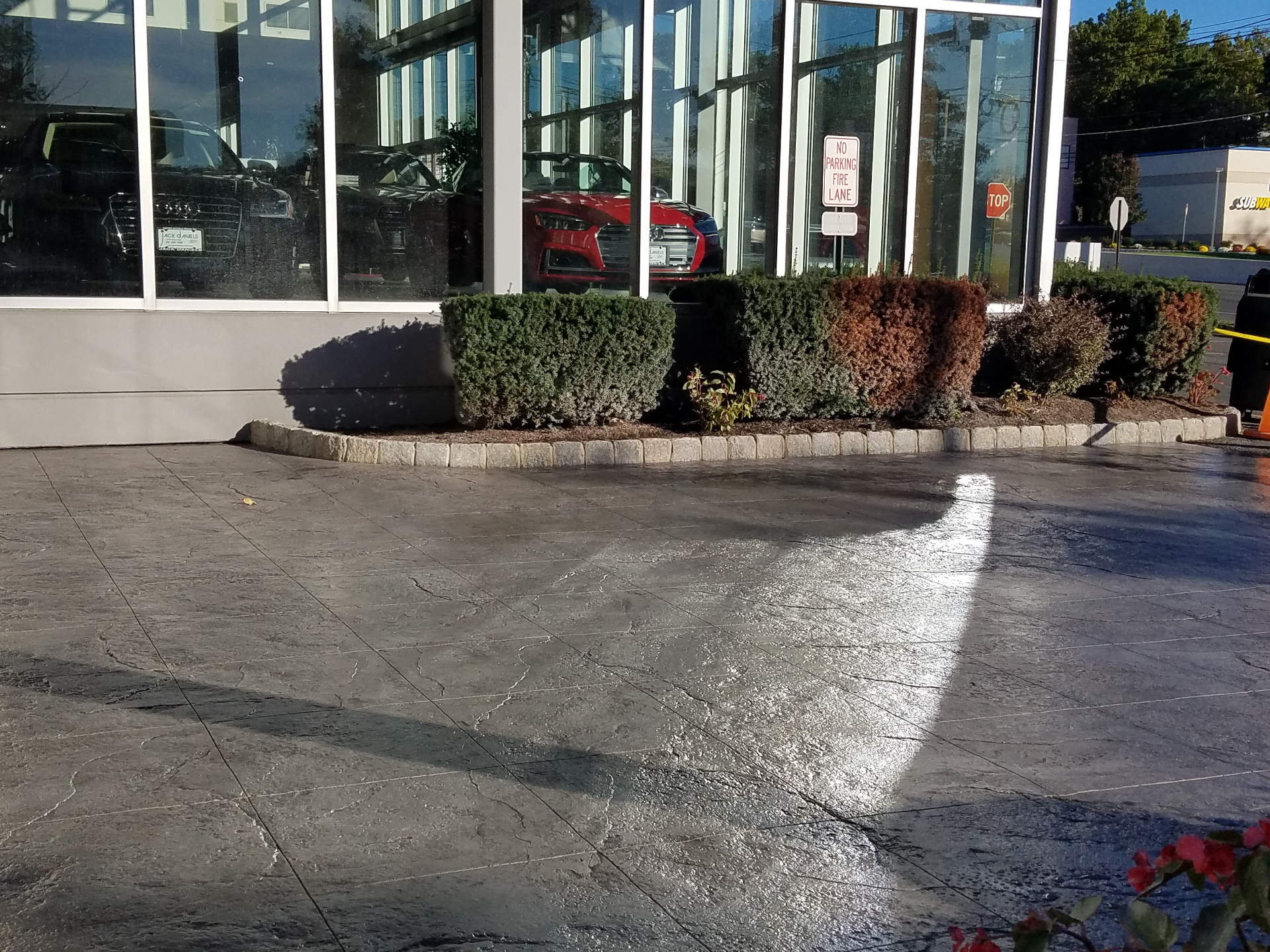 Large stamped concrete drive with granite cobble border