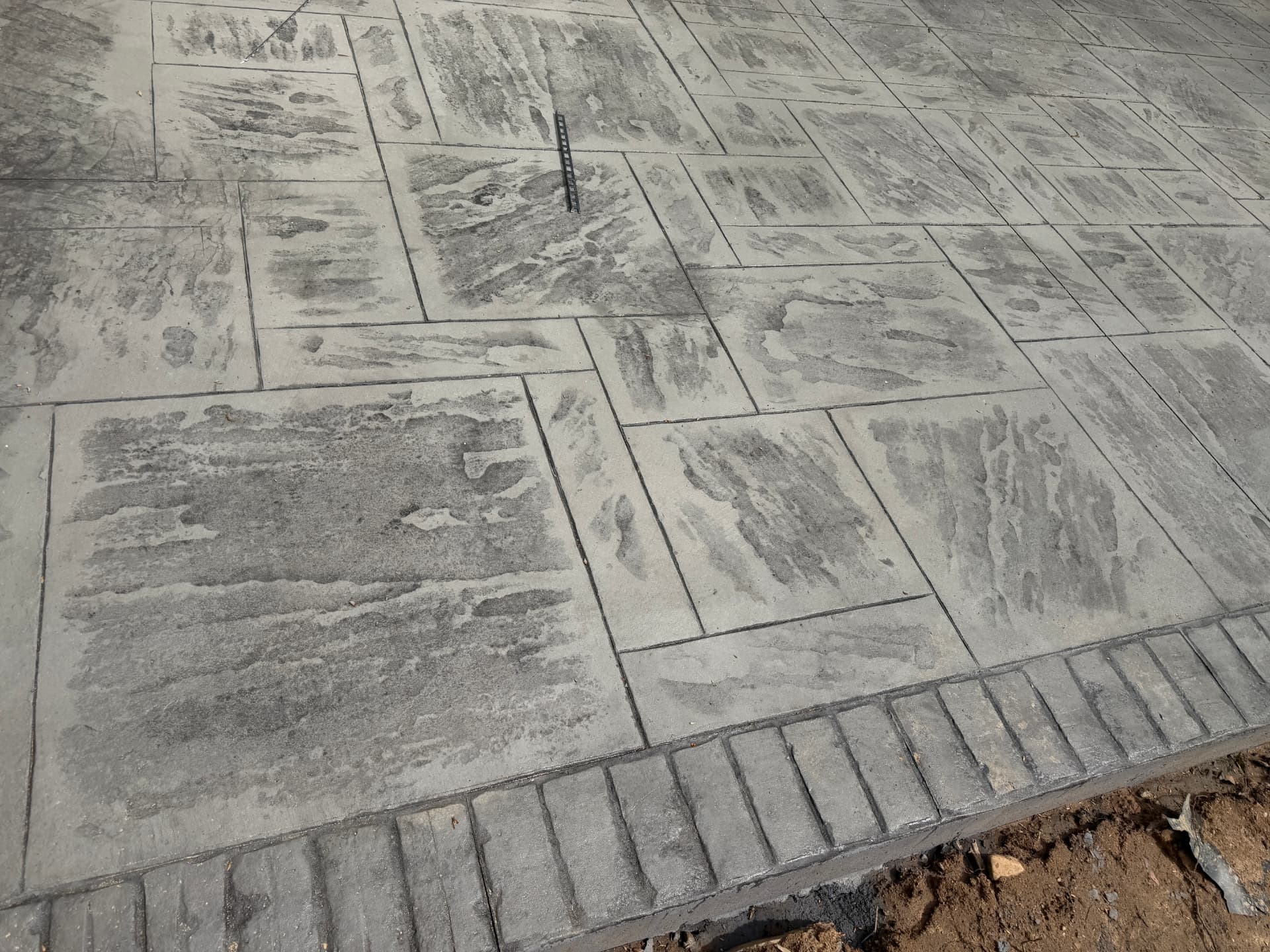 Ashlar slate stamped concrete with brick soldier border